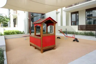 a small playground in front of a building at Breeze haven residences- 2BHK brand new furnished apartment in Dubai