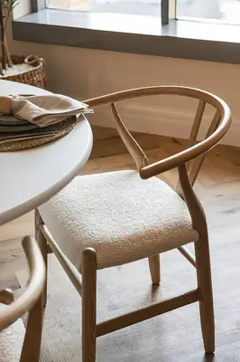 a wooden chair sitting next to a table at The Boulevard Suite Luxury near Burj Khalifa in Dubai