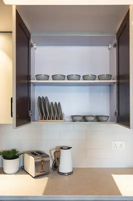 a kitchen with a counter with bowls and a toaster at The Boulevard Suite Luxury near Burj Khalifa in Dubai