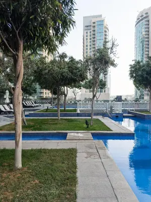 a park with blue water and trees and buildings at The Boulevard Suite Luxury near Burj Khalifa in Dubai