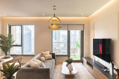a living room with a couch and a tv at The Boulevard Suite Luxury near Burj Khalifa in Dubai