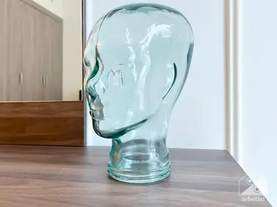 a clear glass head vase sitting on a table at Your Perfect Meydan Getaway 1B Polo Residence C3 in Dubai