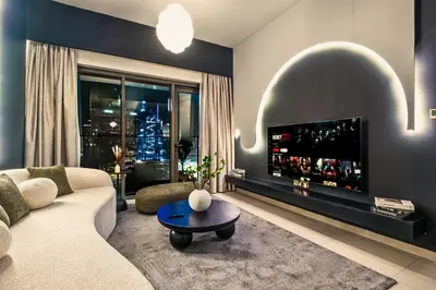 a living room with a couch and a tv at Luxury At The Top- Iconic Burj Views-Dubai Mall Access 2BR by Maxx Value Homes in Dubai