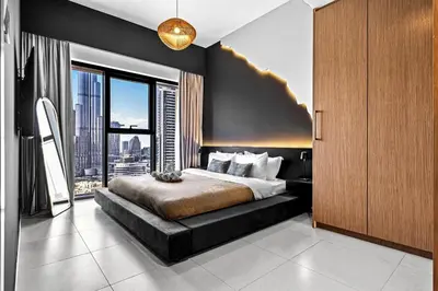 a bedroom with a large bed and a large window at Luxury At The Top- Iconic Burj Views-Dubai Mall Access 2BR by Maxx Value Homes in Dubai