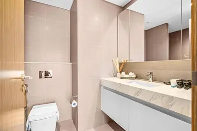 a bathroom with a toilet and a sink at Luxury At The Top- Iconic Burj Views-Dubai Mall Access 2BR by Maxx Value Homes in Dubai