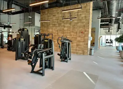 a gym with rows of treadmills and elliptical machines at Apartment Downtown Dubai in Dubai