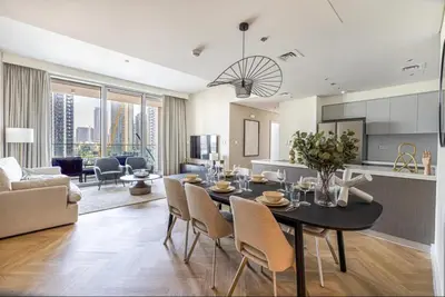 a kitchen and living room with a table and chairs at Apartment Downtown Dubai in Dubai