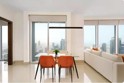 a living room with a table and chairs and a couch at Penthouse Downtown Dubai in Dubai