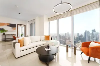 a living room with a white couch and a table at Penthouse Downtown Dubai in Dubai