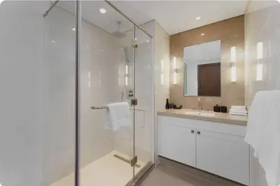 a bathroom with a glass shower and a sink at Penthouse Downtown Dubai in Dubai