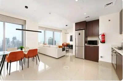a kitchen and living room with a table and chairs at Penthouse Downtown Dubai in Dubai