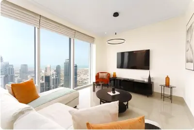a living room with a couch and a flat screen tv at Penthouse Downtown Dubai in Dubai