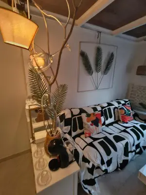 a living room with a couch and a lamp at Stylish Boutique Loft Duplex, Near Circle Mall, Balcony, Fast WiFi, 2 Pools and Gym in Dubai