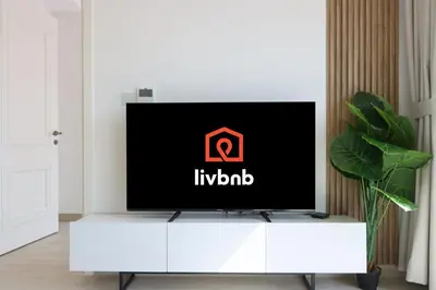 a flat screen tv sitting on top of a white cabinet in a living room at Livbnb-Modern Living 1B Apartment in JVC in Dubai