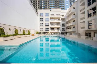a swimming pool in the middle of a building at Livbnb-Modern Living 1B Apartment in JVC in Dubai