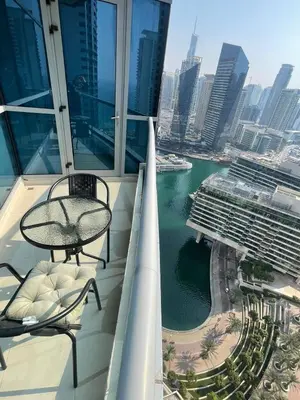 a balcony with a table and chairs on a building at Lake & Beach view Studio in the Center of Marina in Dubai