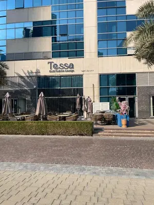 a building with a tesla sign in front of it at Lake & Beach view Studio in the Center of Marina in Dubai
