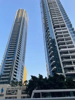two tall buildings next to each other at Lake & Beach view Studio in the Center of Marina in Dubai