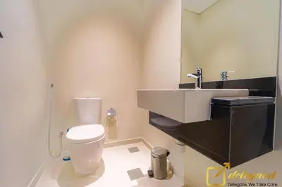 a bathroom with a white toilet and a sink at Prestine 3BR Villa in DH2 by deleguest in Dubai