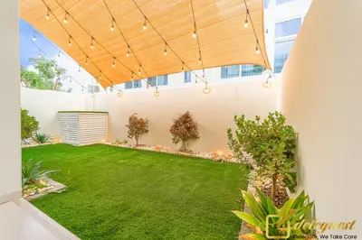a large backyard with a green lawn at Prestine 3BR Villa in DH2 by deleguest in Dubai