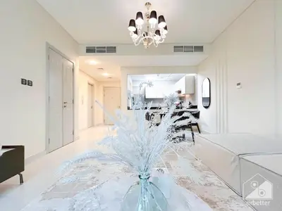 a living room with a glass vase on the floor at Stylish Escape in Meydan 1B Polo Residence C3 in Dubai