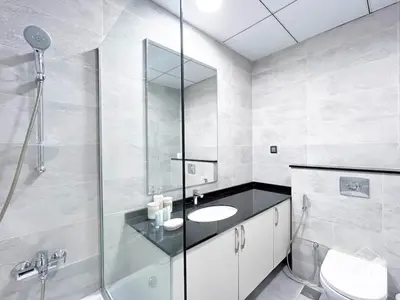 a bathroom with a glass shower and a sink at Stylish Escape in Meydan 1B Polo Residence C3 in Dubai