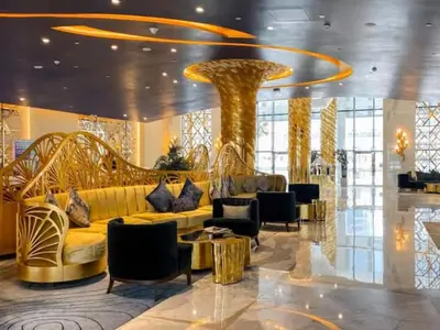 a lobby with a couch and chairs in a building at Vogue Business Bay Damac Maison Prive near Burj Khalifa and Dubai Mall, Studio Apartment with Canal and City View, Access to all Amenities in Dubai