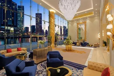 a large lobby with a view of a city at Vogue Business Bay Damac Maison Prive near Burj Khalifa and Dubai Mall, Studio Apartment with Canal and City View, Access to all Amenities in Dubai