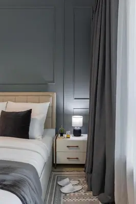a bedroom with a bed and a table with a lamp at Near Burj Khalifa, Dubai Fountain view, Dubai Mall in 10 mins walk in Dubai