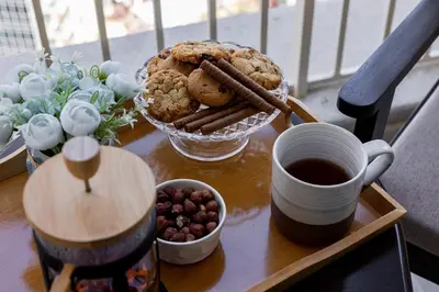 a table with a tray of cookies and a cup of coffee at Near Burj Khalifa, Dubai Fountain view, Dubai Mall in 10 mins walk in Dubai