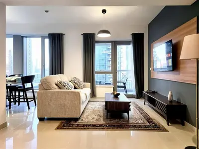 a living room with a couch and a table at Near Burj Khalifa, Dubai Fountain view, Dubai Mall in 10 mins walk in Dubai
