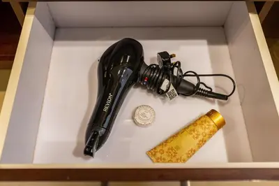 a hair dryer and a wine glass in a box at Near Burj Khalifa, Dubai Fountain view, Dubai Mall in 10 mins walk in Dubai