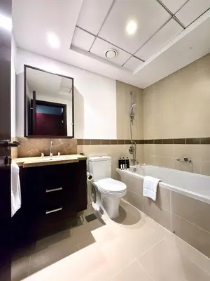 a bathroom with a toilet and a sink and a tub at Near Burj Khalifa, Dubai Fountain view, Dubai Mall in 10 mins walk in Dubai