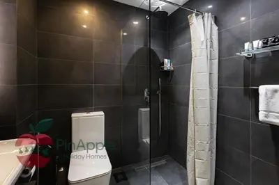 a bathroom with a shower and a toilet and a sink at Sea and Dubai Ain view Close to Private Beach in Dubai