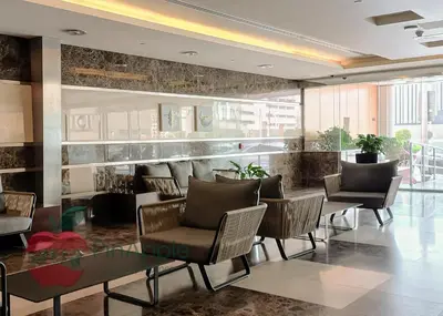 a lobby with chairs and a table in a building at Sea and Dubai Ain view Close to Private Beach in Dubai