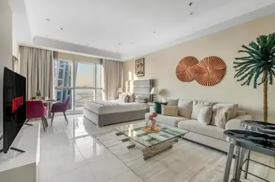a living room with a couch and a table at Spectacular Studio & 1 Bedroom Units By Costa close to metro in Dubai
