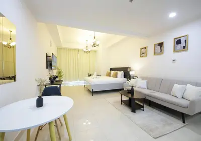 a living room with a couch and a bed at Spectacular Studio & 1 Bedroom Units By Costa close to metro in Dubai