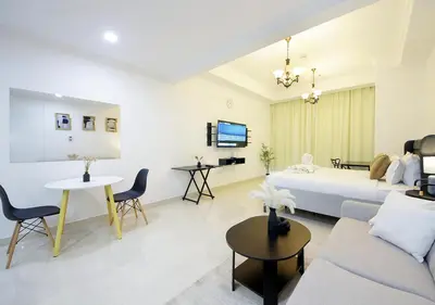 a hotel room with a bed and a living room at Spectacular Studio & 1 Bedroom Units By Costa close to metro in Dubai