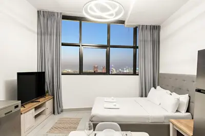 a bedroom with a bed and a large window at Studio Dubai, Cozy Luxury Stay Near Downtown Dining Shopping & Leisure in Dubai
