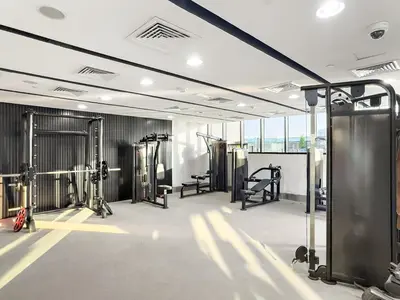 a gym with treadmills and machines in a room at Studio Dubai, Cozy Luxury Stay Near Downtown Dining Shopping & Leisure in Dubai