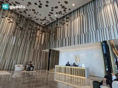 a lobby with people sitting at a reception desk at HiGuests - Modern & Stylish 1BR Apt - Near Business Bay Metro in Dubai