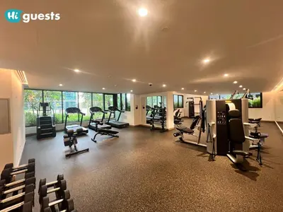 a gym with treadmills and exercise equipment in a building at HiGuests - Modern & Stylish 1BR Apt - Near Business Bay Metro in Dubai