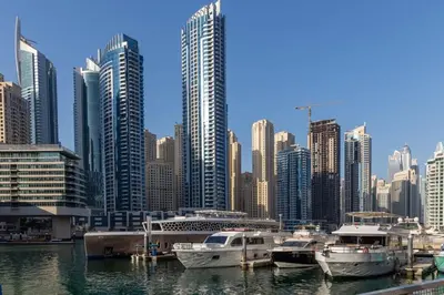 a group of boats docked in a harbor in a city at Frank Porter - West Avenue in Dubai