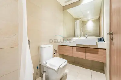 a bathroom with a toilet and a sink at City View Studio Minutes Drive to Burj Khalifa, Azizi Riviera 43, Al Merkadh by Deluxe Holiday Homes in Dubai