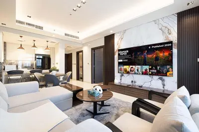 a living room with white furniture and a flat screen tv at Modern 1-Bedroom Apartment with Stunning Burj Khalifa and city Views in Dubai