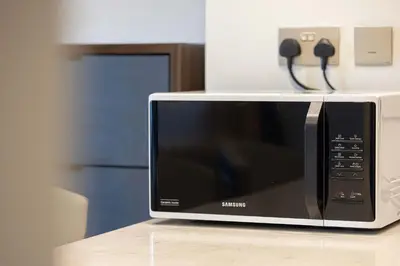 a microwave oven sitting on top of a counter at Modern 1-Bedroom Apartment with Stunning Burj Khalifa and city Views in Dubai