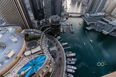 an aerial view of a city with boats in the water at The Captivating in Dubai