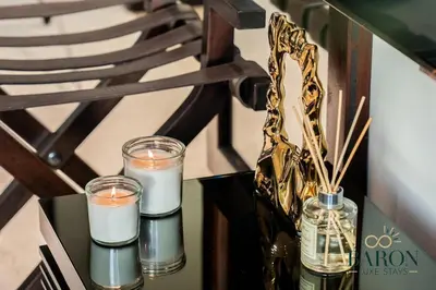three candles in glass jars on a table at The Captivating in Dubai