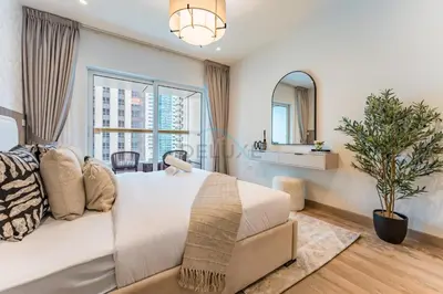 a bedroom with a large bed and a large window at Renovated Unit with Skyscraper Views, Close to JBR Beach, Elite Residence, Dubai Marina by Deluxe Holiday Homes in Dubai