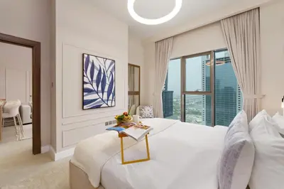 a white bedroom with a large bed and a window at Maison Privee - Modern Living with Premium Amenities close to Marina in Dubai